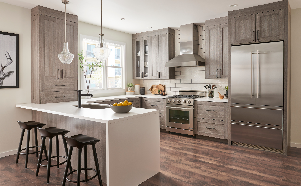 Gray cabinets in a kitchen with waterfall countertops