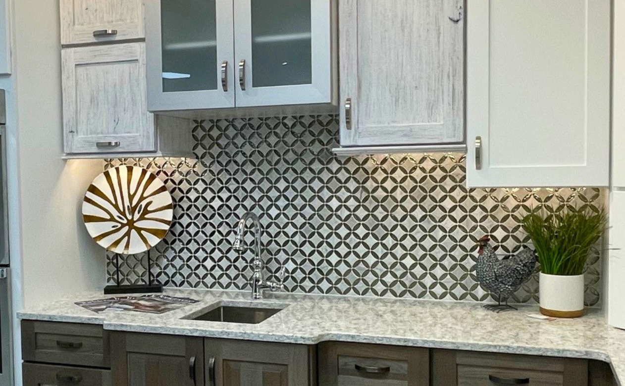tile backsplash in a kitchen with brown and black cabinetry