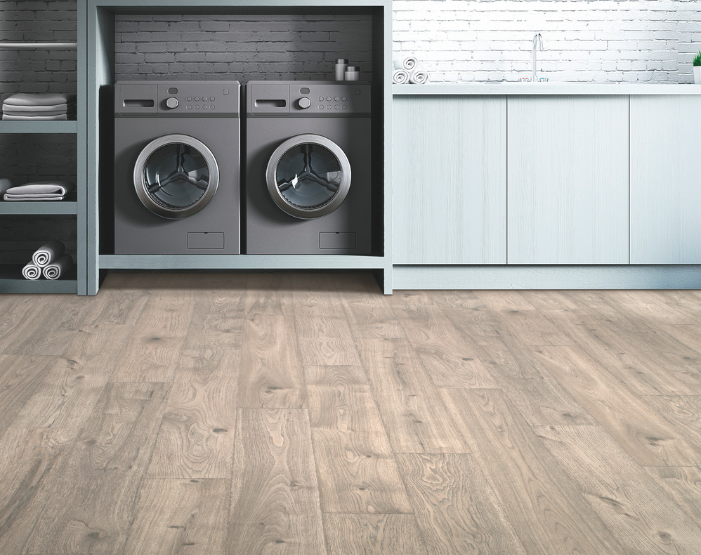 laminate flooring in a laundry room with blue built-in cabinets