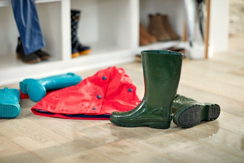 wet boots on hardwood floor in entryway